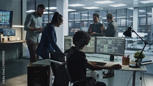 Business Team Collaborating in Modern Office With Multiple Monitors and Technology Workstations