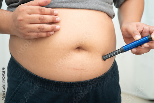 Принти на полотні Asian woman injecting herself diabetes injecting insulin in stomach at home