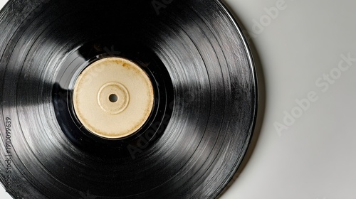 vinyl. A vintage vinyl record isolated on a light grey surface, showcasing subtle texture details. lifestyle magazines.