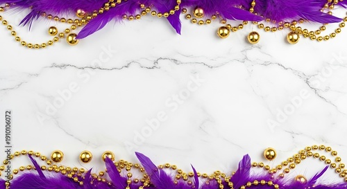 Purple and gold beads and feathers on a marble background.