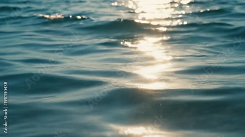 Sunlight shimmers and reflects beautifully on the gentle ripples of the ocean