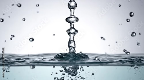 A single water drop creates a beautiful splash and ripples on the surface