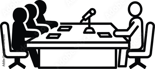 Two individuals engaged in a meeting with a microphone on the table