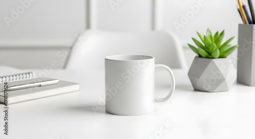 A clean white desk with a mug, plant, and notebook, ready for a productive day