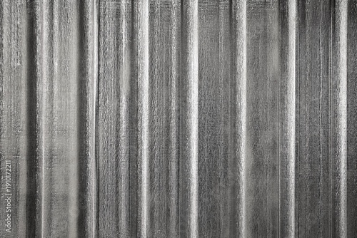 Silver metallic texture background with vertical striped pattern and reflective surface. Abstract foil material suitable for industrial design, modern backdrop, technology concept, and luxury backgrou