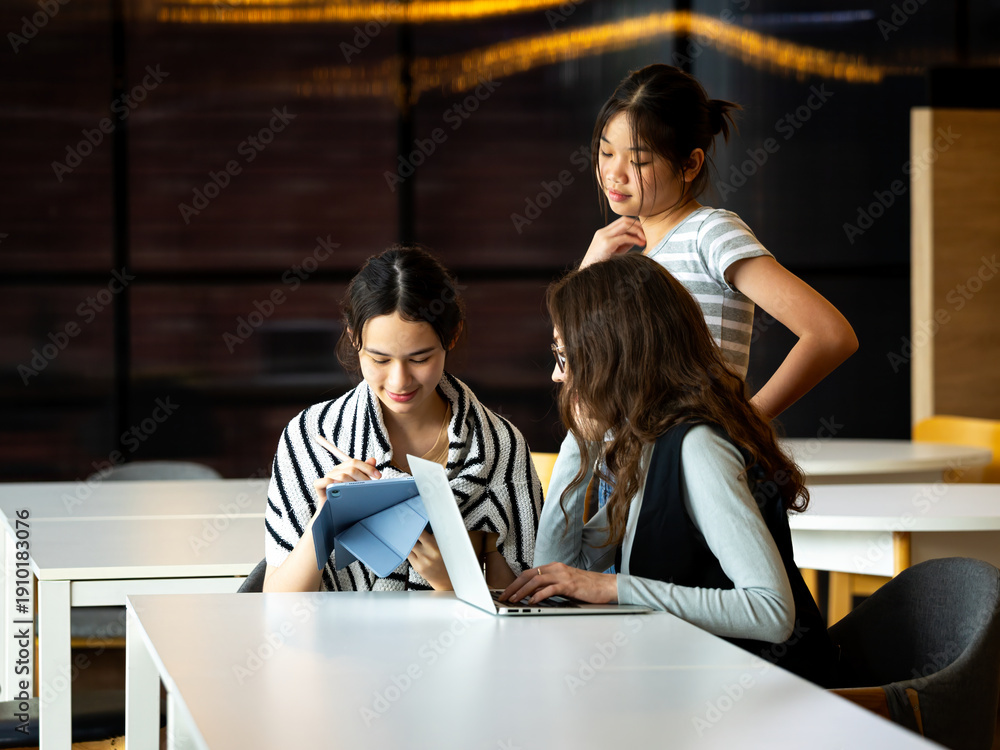 custom made wallpaper toronto digitalMultiracial female students studying together with laptop and tablet in modern university classroom, collaborative learning, digital education, teamwork, academic project, technology in school
