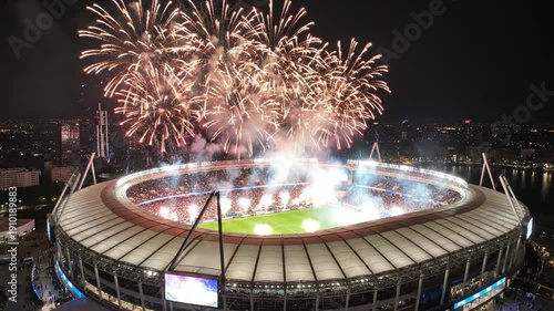 Spectacular Fireworks Exploding Over a Crowded Stadium at Night