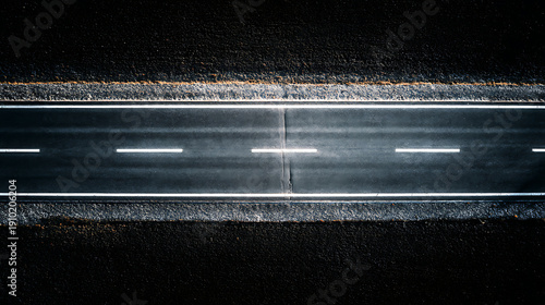 Aerial View of a Dark Asphalt Road with White Lane Markings