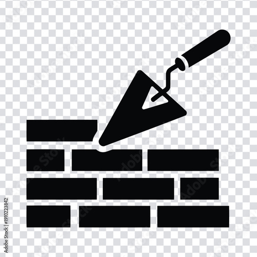 Black silhouette of a trowel on a brick wall with a handle