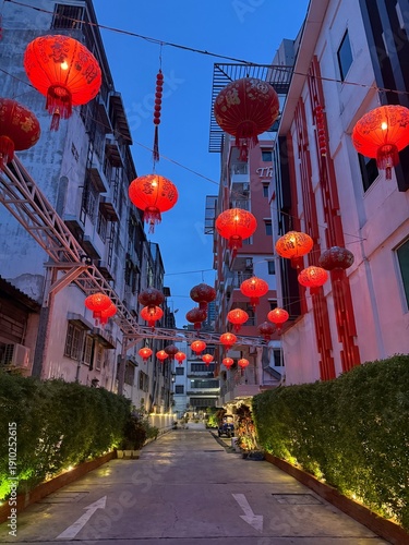 Lanternes rouges chinoises suspendues dans une ruelle urbaine en Thaïlande au crépuscule