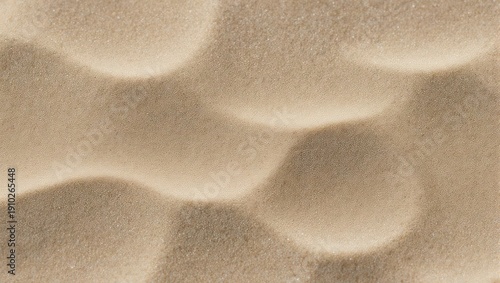 Close-up view of rippled sand dunes with soft light and shadow.