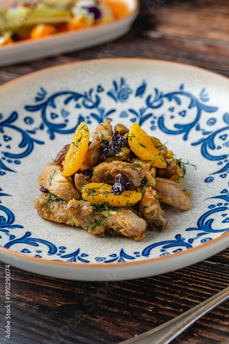 Wallpaper Mural Chicken dish with dried fruits served in traditional patterned plate Torontodigital.ca
