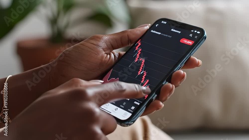 Wallpaper Mural Person viewing stock market data on smartphone Torontodigital.ca