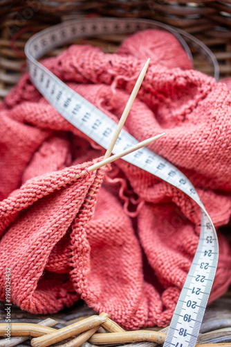 Knitting project with yarn needles and measuring tape
