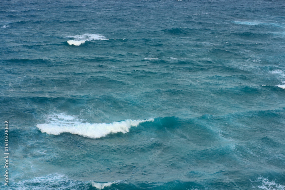 Fototapeta premium Ocean waves and water background. Deep blue sea surface view. Calm and powerful nature seascape with copy space. Tranquil horizon line.