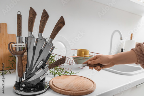 Female hand taking knife fr...