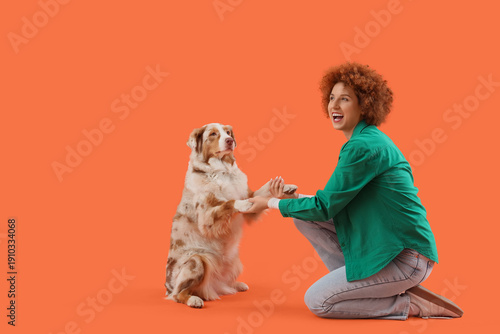 Redhead young woman holding...