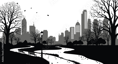 Silhouetted cityscape with bare trees and winding park pathway