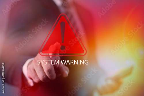 Businessman touching virtual a glowing red system warning sign. representing cyber attack, data breach, security alert, and computer system hacking detection warning concept.