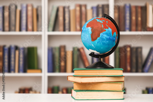 Stack of books and globe on...