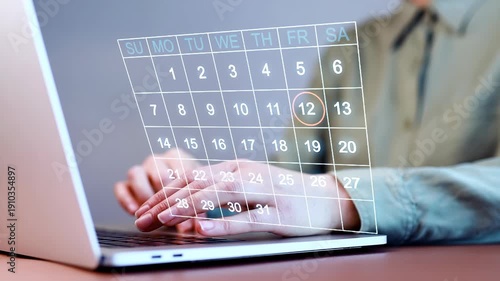 Working on a laptop with a calendar displayed for scheduling tasks and managing time in an office setting in the morning hours.