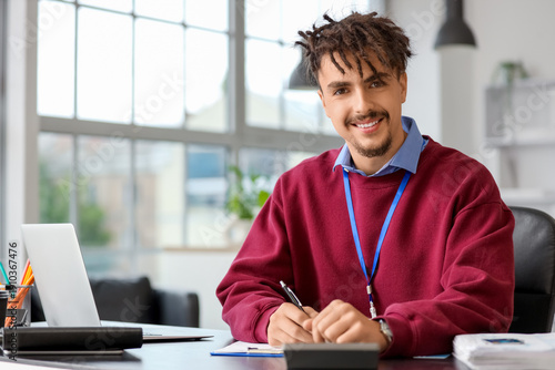 Young male bank manager wor...