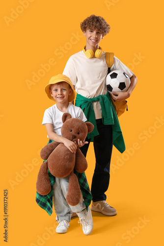 Cute brothers with teddy be...