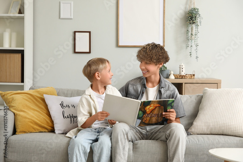 Cute brothers reading book ...