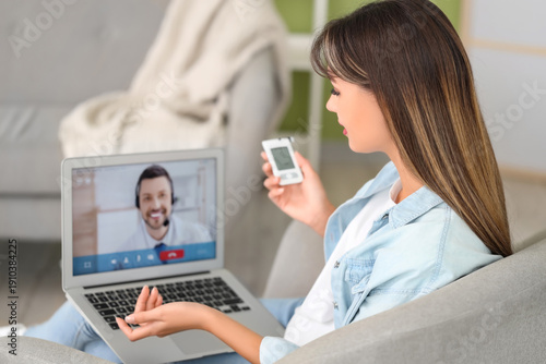 Diabetic young woman with glucometer receiving online consultation from docto...