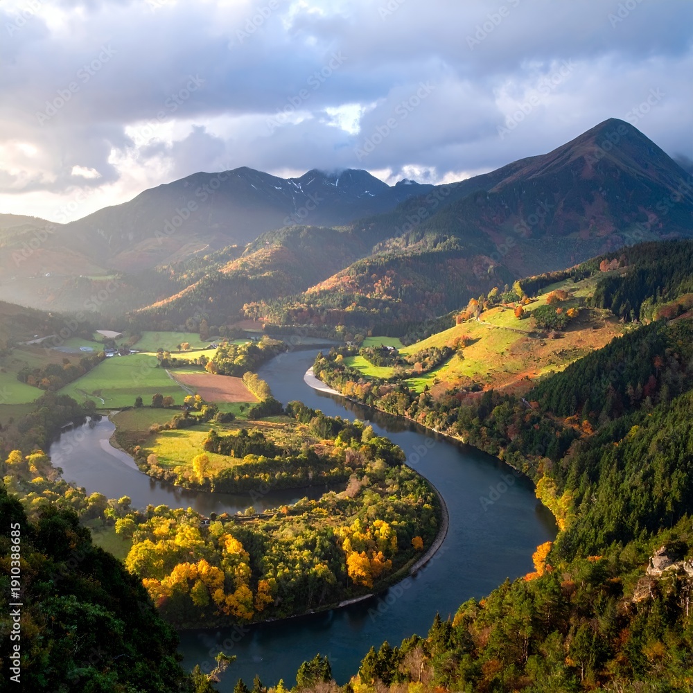 Naklejka premium Serpentine river winds through autumn forest and rolling hills under dramatic sky