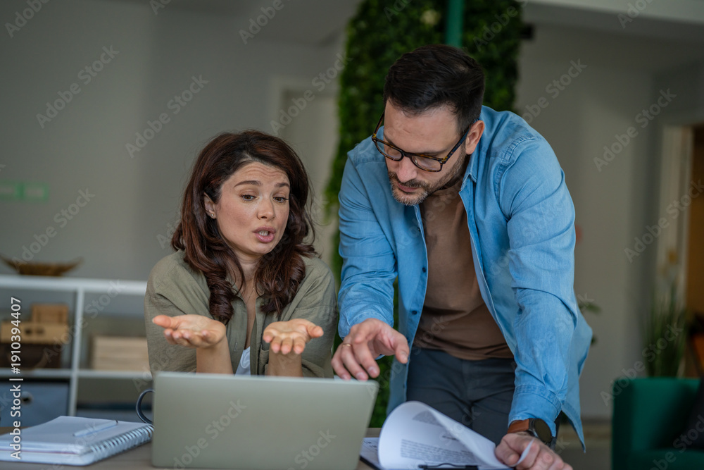 Fototapeta premium Couple experiencing financial confusion and solving problems at home