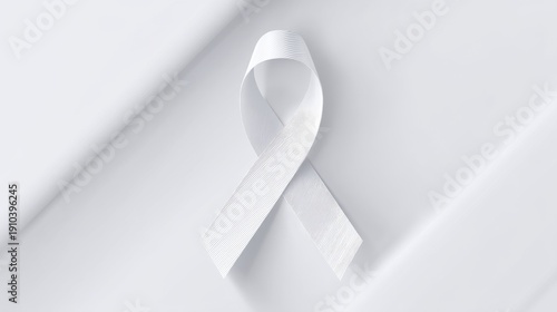 White cancer awareness ribbon on a plain background promoting health and support for those affected by cancer