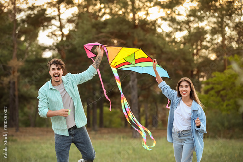 Happy young couple flying k...