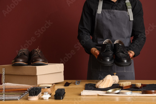 Male shoemaker with polishe...