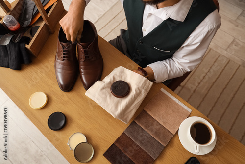 Male shoemaker with leather...