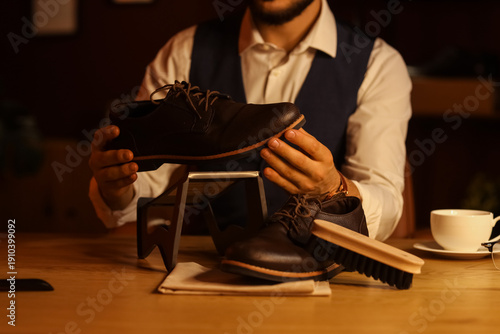 Man with shoes and cleaning...