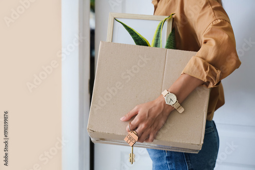 Young woman with key and bo...