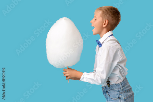 Teen boy eating cotton cand...