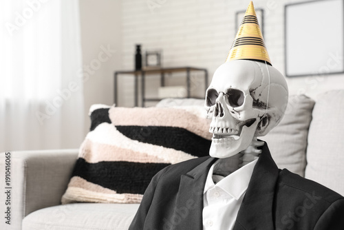 Skeleton in party hat and s...