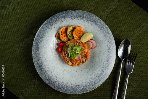 Wallpaper Mural Elegant plated dish with salmon tartare garnished with fresh vegetables and lime Torontodigital.ca