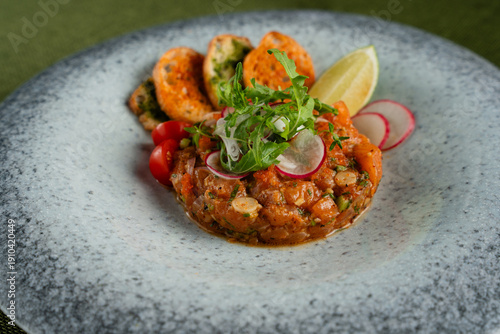 Wallpaper Mural Vibrant Dish of Salmon Tartare Garnished with Fresh Herbs and Citrus on a Textured Plate Torontodigital.ca