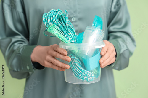 Woman holding bucket with p...