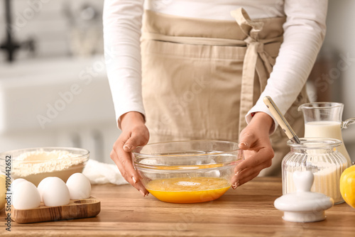 Woman holding bowl with egg...