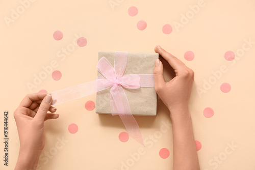 Female hands with gift box ...