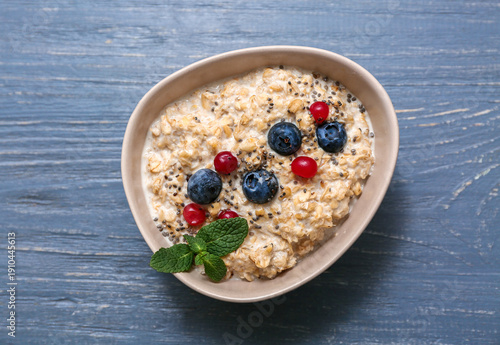 Bowl with tasty oatmeal, ch...