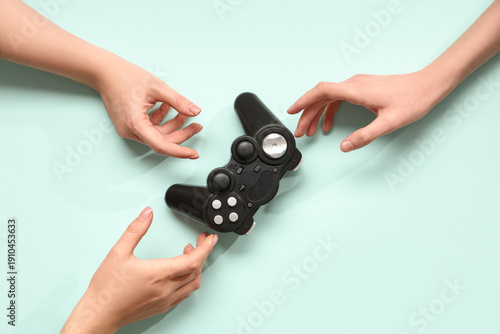 Wallpaper Mural Female hands with modern game pad on color background Torontodigital.ca