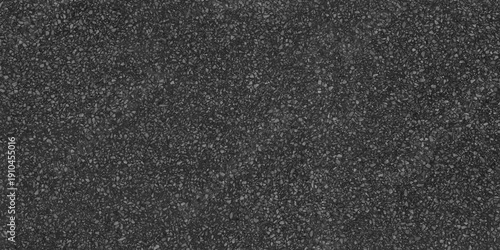 Photos high density of samll, light grey aggregate chips embedded in a deep charcoal matrix, creating  a sophisticated look,dark charcoal texture background