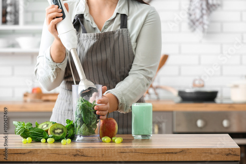 Young woman preparing green...