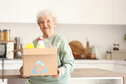 Senior woman with box of ga...
