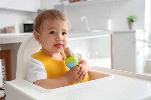 Cute little baby with bib a...